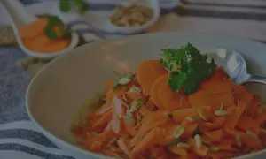 Carottes Vichy grand-mère, une salade fraîche et colorée, garnie de persil et de graines de tournesol. Un délice simple et savoureux.